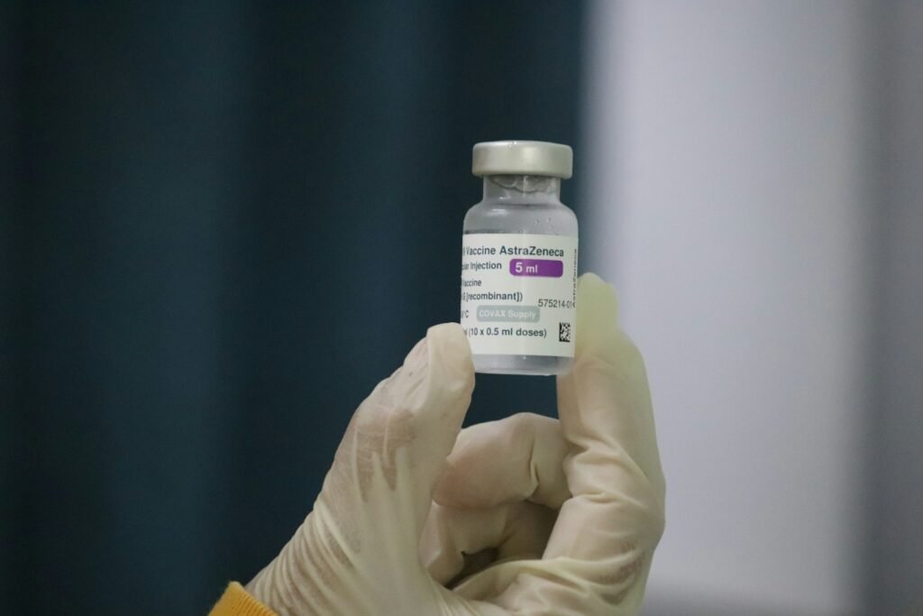 person holding white plastic bottle